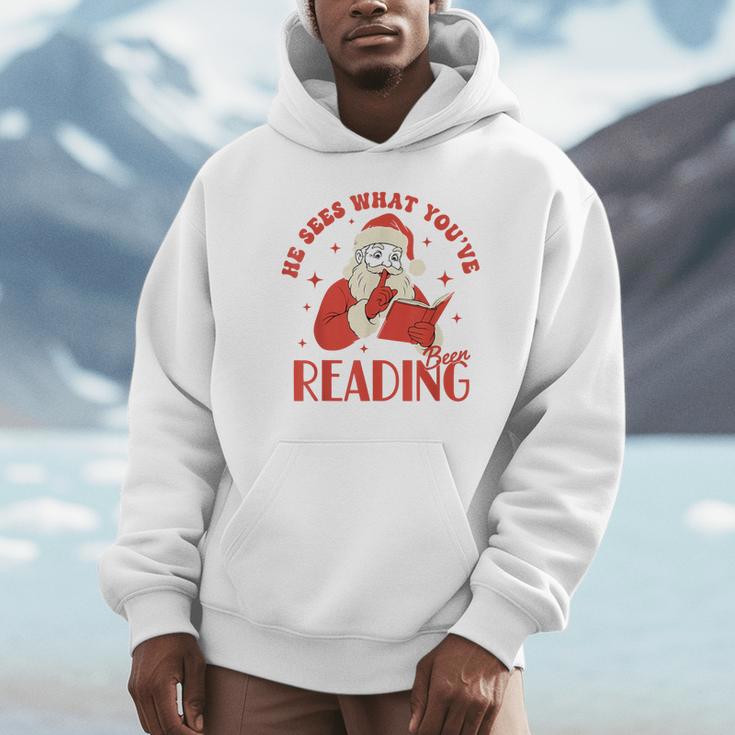 He Sees What You'Ve Been Reading Santa Book Unisex Hoodie He Sees What You'Ve Been Reading Santa Book Unisex Hoodie