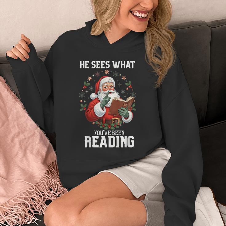 He Sees What You'Ve Been Reading Santa Book Lover Unisex Hoodie He Sees What You'Ve Been Reading Santa Book Lover Unisex Hoodie