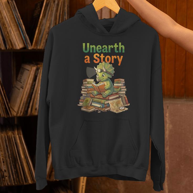Unearth a Story Triceratops Dinosaur Reading Books Cute Dino Unisex Hoodie Unearth a Story Triceratops Dinosaur Reading Books Cute Dino Unisex Hoodie
