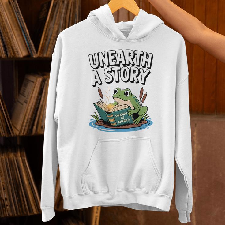 Unearth a Story Frog Reading a Book Summer 2026 Premium Tri-Blend Unisex Hoodie