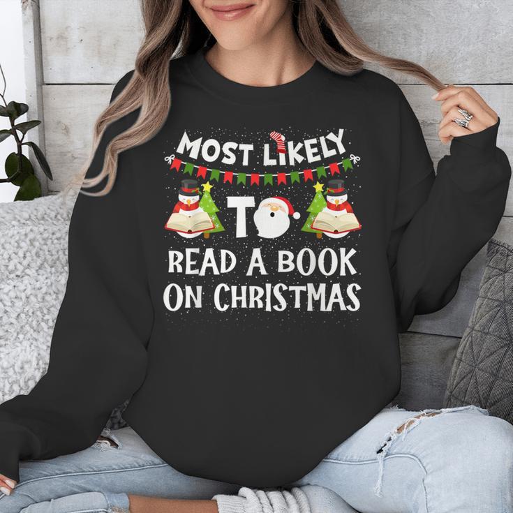 Most Likely To Read A Book On Christmas Snowman Family Unisex Sweatshirt
