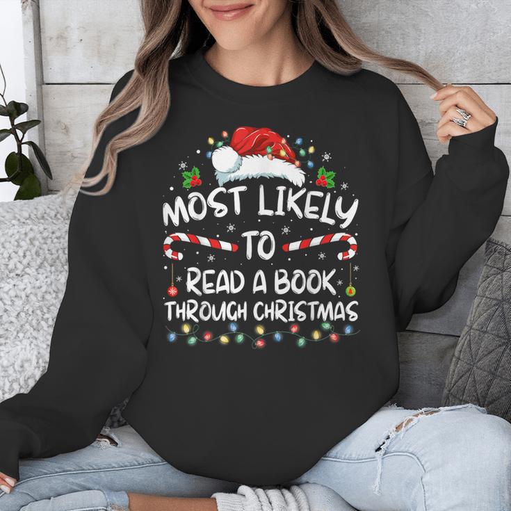Most Likely To Read A Book Through Christmas Xmas Unisex Sweatshirt Most Likely To Read A Book Through Christmas Xmas Unisex Sweatshirt