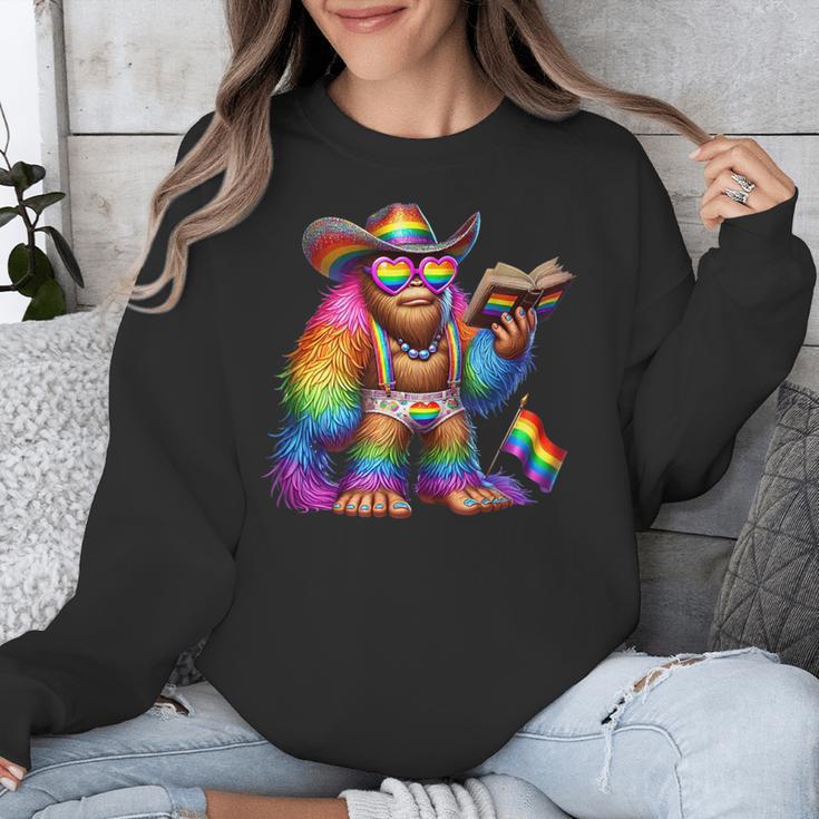 Rainbow Pride Bigfoot Reading Book With Heart Glasses Unisex Sweatshirt