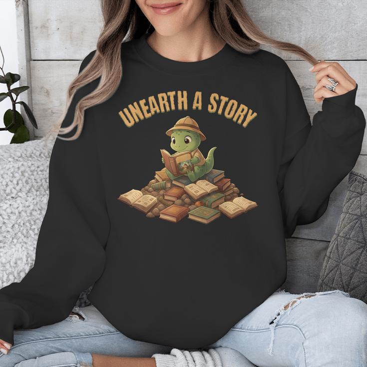 Unearth a Story Dinosaur Reading Books Summer 2026 Unisex Sweatshirt Unearth a Story Dinosaur Reading Books Summer 2026 Unisex Sweatshirt