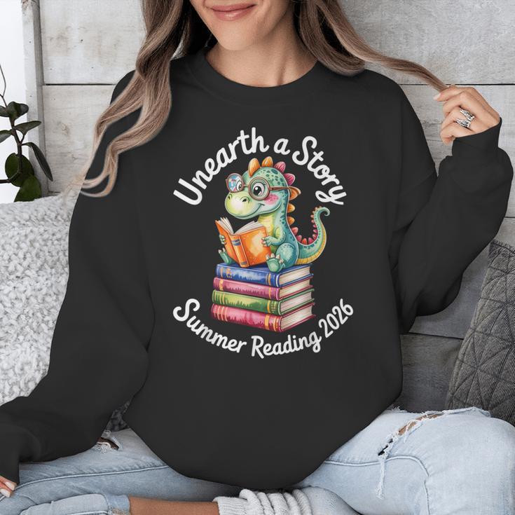 Unearth a Story Summer Reading 2026 Book Lover Dino Fun Unisex Sweatshirt Unearth a Story Summer Reading 2026 Book Lover Dino Fun Unisex Sweatshirt
