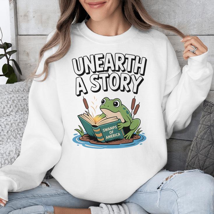 Unearth a Story Frog Reading a Book Summer 2026 Premium Tri-Blend Unisex Sweatshirt Unearth a Story Frog Reading a Book Summer 2026 Premium Tri-Blend Unisex Sweatshirt