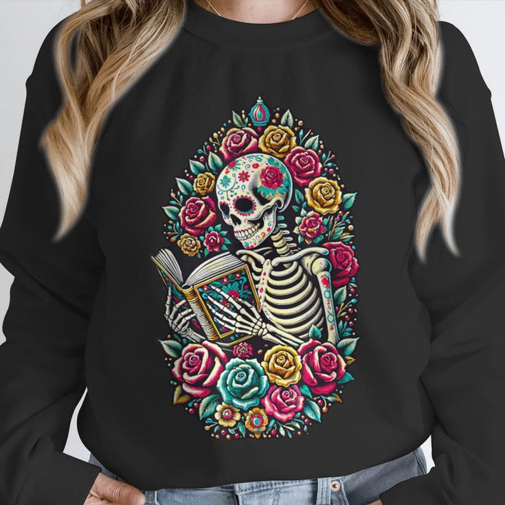 Book Lover Skeleton Reading With Dia De Los Muertos Flowers Unisex Sweatshirt Book Lover Skeleton Reading With Dia De Los Muertos Flowers Unisex Sweatshirt