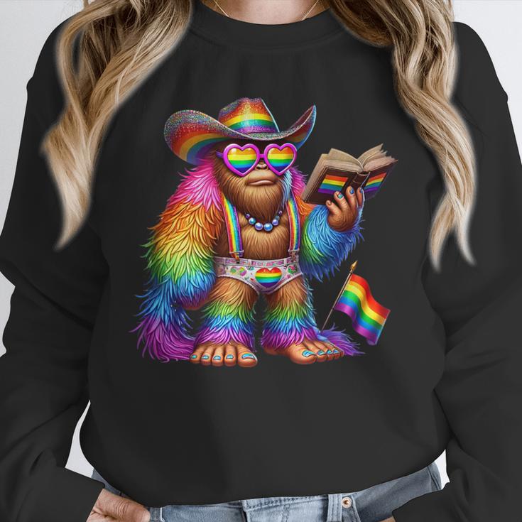 Rainbow Pride Bigfoot Reading Book With Heart Glasses Unisex Sweatshirt