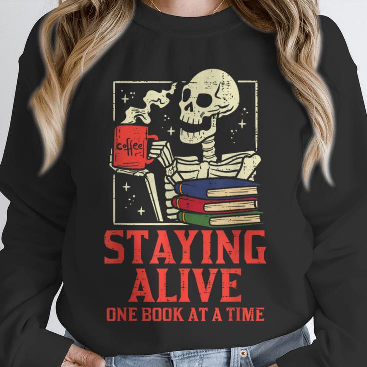 Staying Alive One Book At A Time Skeleton Reading Librarian Unisex Sweatshirt Staying Alive One Book At A Time Skeleton Reading Librarian Unisex Sweatshirt