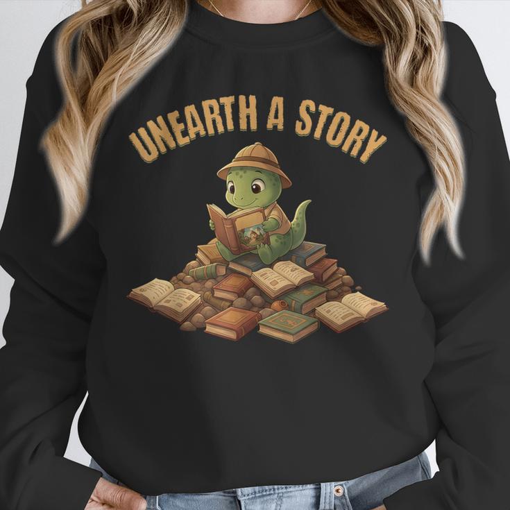 Unearth a Story Dinosaur Reading Books Summer 2026 Unisex Sweatshirt Unearth a Story Dinosaur Reading Books Summer 2026 Unisex Sweatshirt