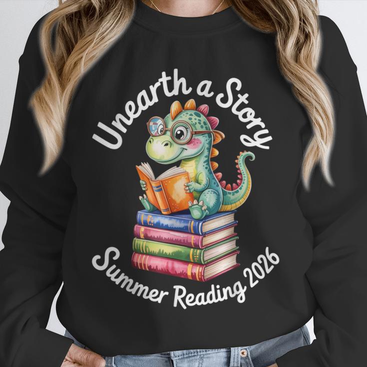 Unearth a Story Summer Reading 2026 Book Lover Dino Fun Unisex Sweatshirt Unearth a Story Summer Reading 2026 Book Lover Dino Fun Unisex Sweatshirt