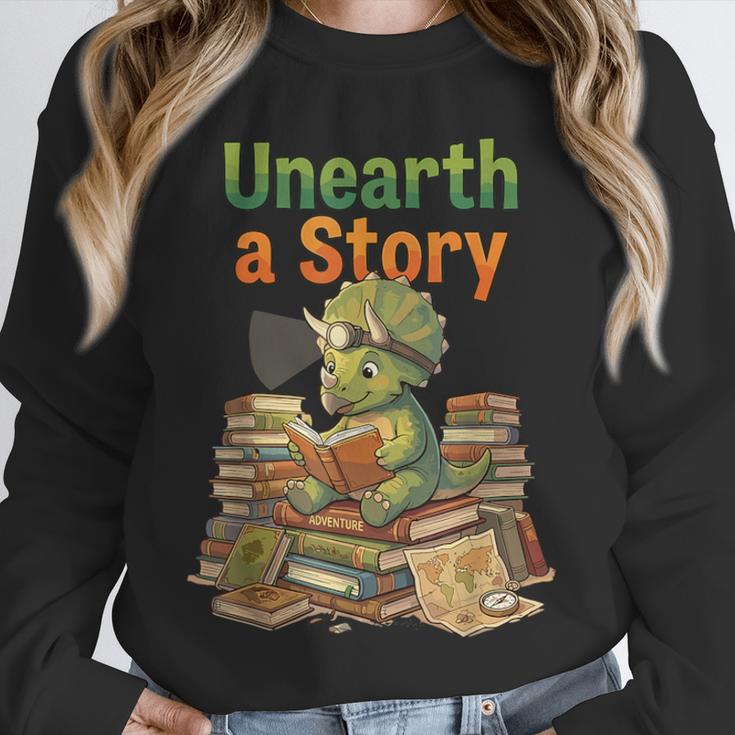 Unearth a Story Triceratops Dinosaur Reading Books Cute Dino Unisex Sweatshirt Unearth a Story Triceratops Dinosaur Reading Books Cute Dino Unisex Sweatshirt