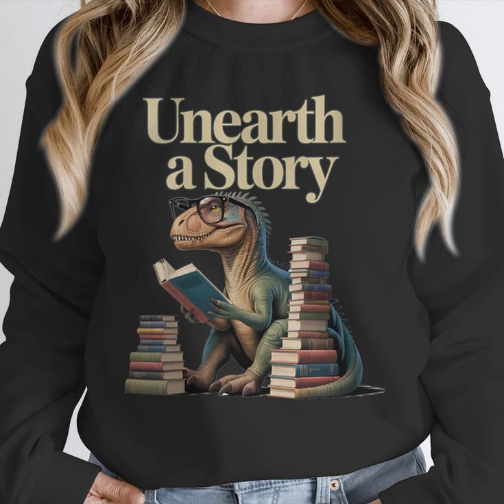 Women's Unearth A Story Dinosaur Reading a Library Book Unisex Sweatshirt
