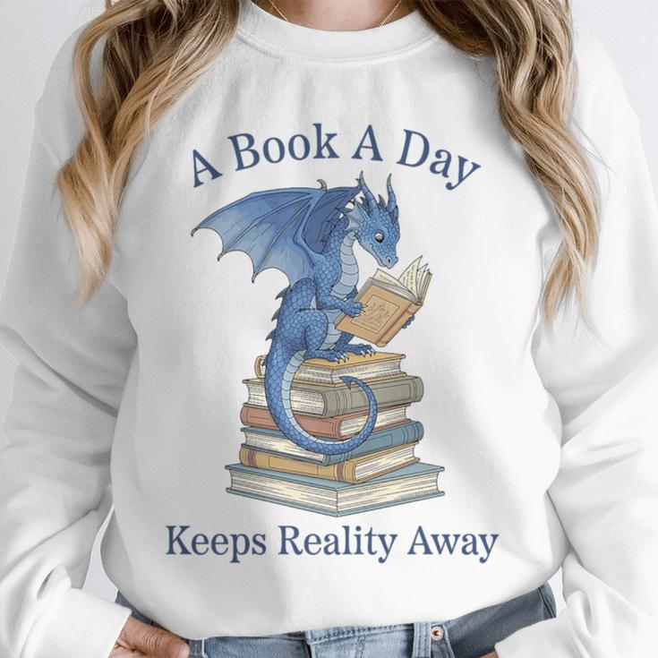 A Book A Day Keeps Reality Away Premium Tri-Blend Unisex Sweatshirt
