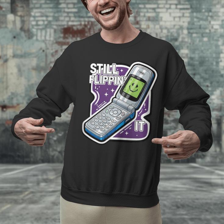 Still Flippin' It Retro Flip Phone 90s Y2K Nostalgia Unisex Sweatshirt Still Flippin' It Retro Flip Phone 90s Y2K Nostalgia Unisex Sweatshirt