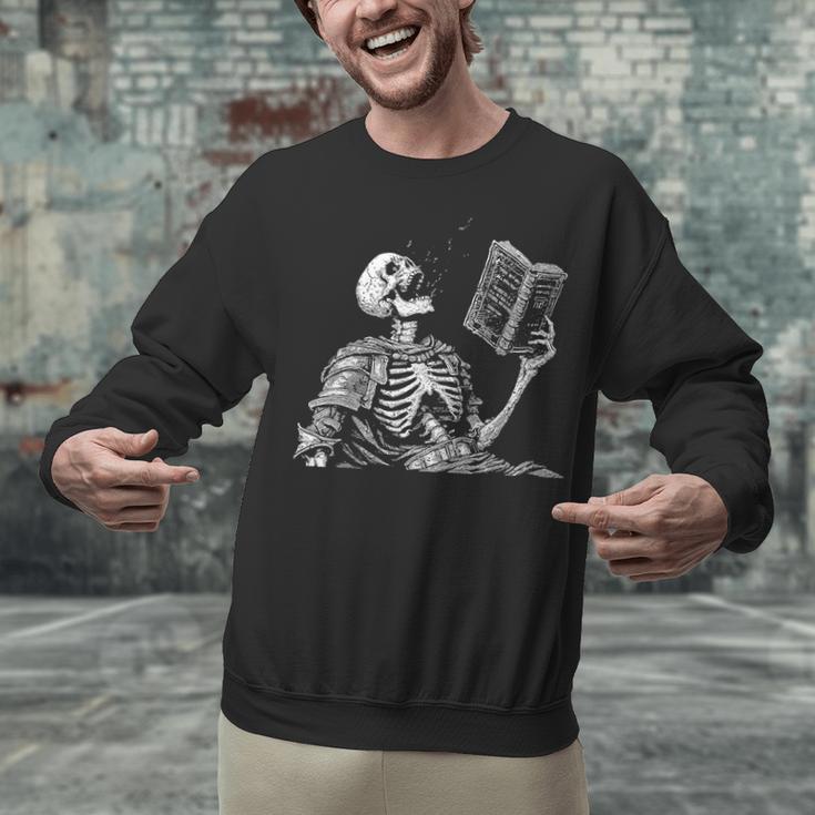 Hilarious Skeleton Holding a Book And Laughing Gothic Unisex Sweatshirt