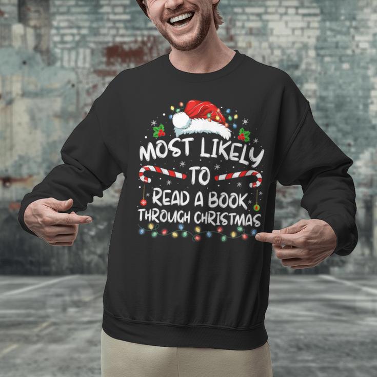Most Likely To Read A Book Through Christmas Xmas Unisex Sweatshirt Most Likely To Read A Book Through Christmas Xmas Unisex Sweatshirt