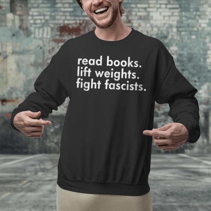 Read Books Lift Weights Fight Fascists Reading Activism Meme Unisex Sweatshirt Read Books Lift Weights Fight Fascists Reading Activism Meme Unisex Sweatshirt