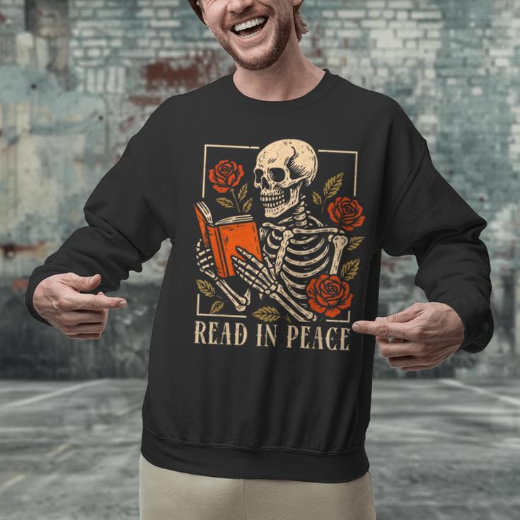 Read In Peace Skeleton Reading Book Halloween Teacher Unisex Sweatshirt