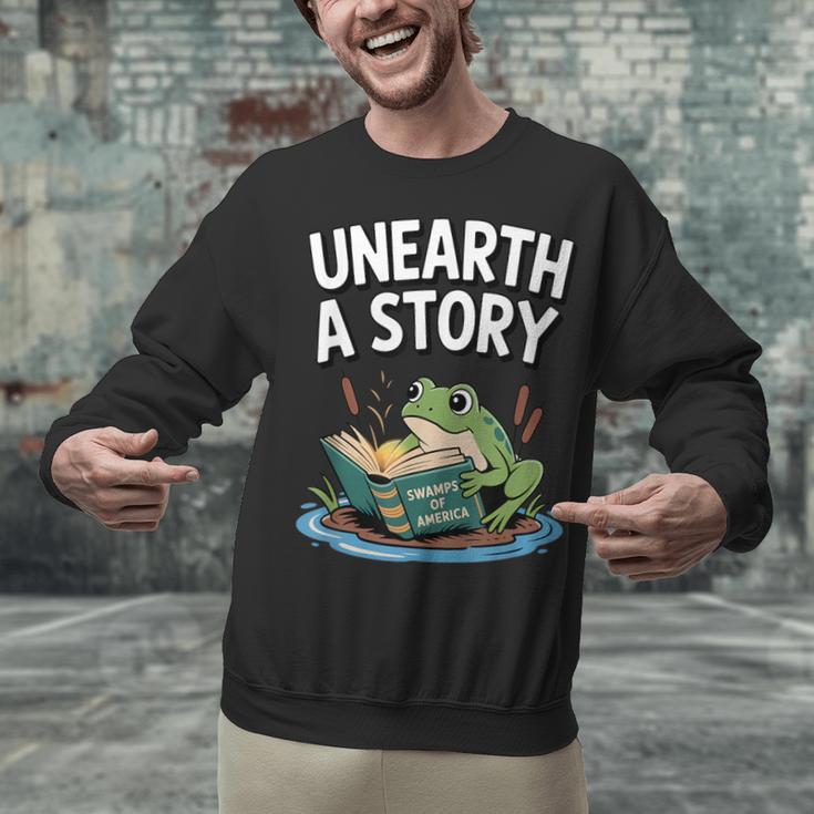 Unearth a Story Frog Reading a Book Summer 2026 Unisex Sweatshirt