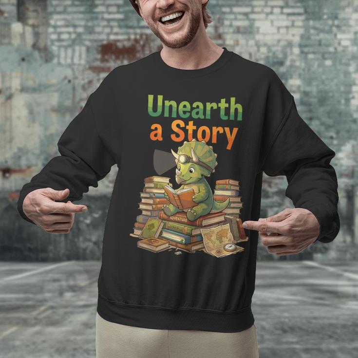 Unearth a Story Triceratops Dinosaur Reading Books Cute Dino Unisex Sweatshirt Unearth a Story Triceratops Dinosaur Reading Books Cute Dino Unisex Sweatshirt