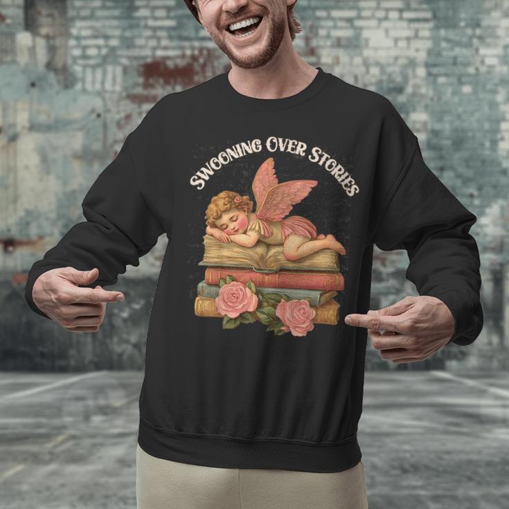 Valentine's Swooning Over Stories Cupid And Book Lover Tee Unisex Sweatshirt