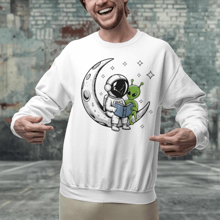 Astronaut Reading Book To Alien Moon Space Astronomy Unisex Sweatshirt