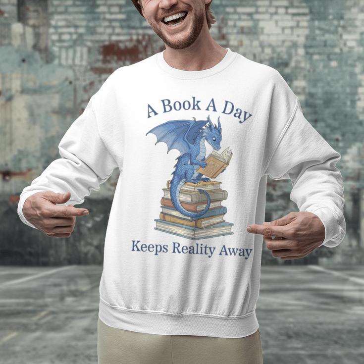 A Book A Day Keeps Reality Away Premium Tri-Blend Unisex Sweatshirt