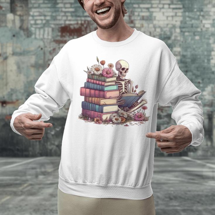 Reading A Book Per Day Keeps Reality Away Skeleton Books Unisex Sweatshirt