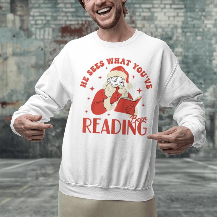 He Sees What You'Ve Been Reading Santa Book Unisex Sweatshirt