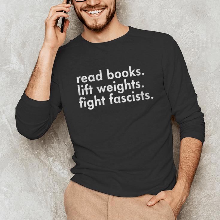 Women's Read Books Lift Weights Fight Fascists Reading Activism Meme Unisex Long Sleeve T-Shirt Women's Read Books Lift Weights Fight Fascists Reading Activism Meme Unisex Long Sleeve T-Shirt