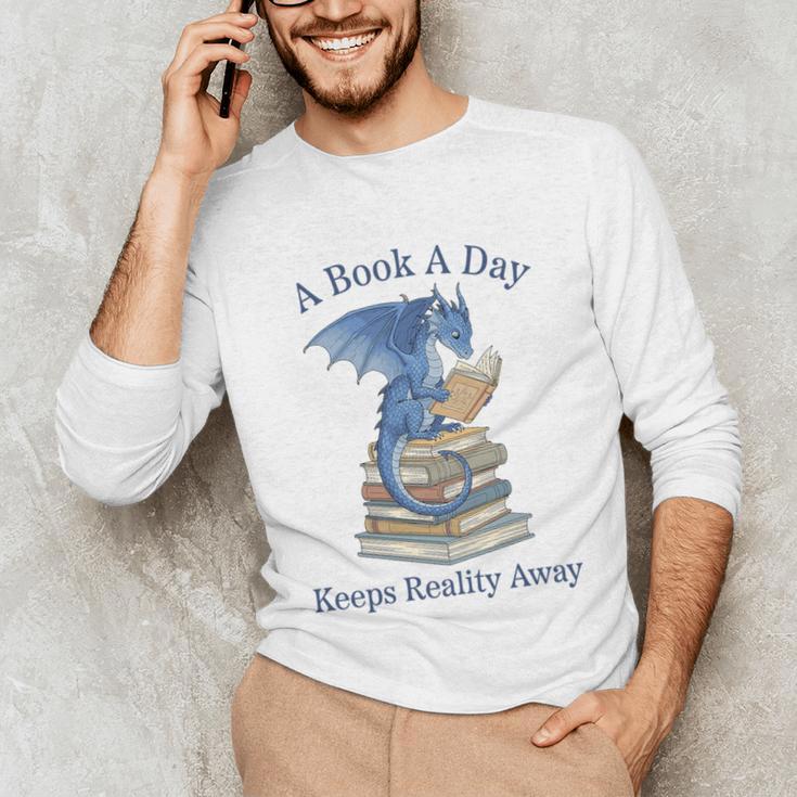 A Book A Day Keeps Reality Away Premium Tri-Blend Unisex Long Sleeve T-Shirt A Book A Day Keeps Reality Away Premium Tri-Blend Unisex Long Sleeve T-Shirt