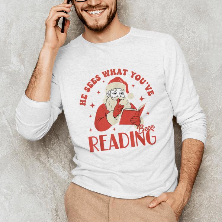 He Sees What You'Ve Been Reading Santa Book Unisex Long Sleeve T-Shirt He Sees What You'Ve Been Reading Santa Book Unisex Long Sleeve T-Shirt