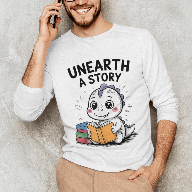 Unearth a Story Cute Dinosaur Summer Reading 2026 Dino Book Unisex Long Sleeve T-Shirt