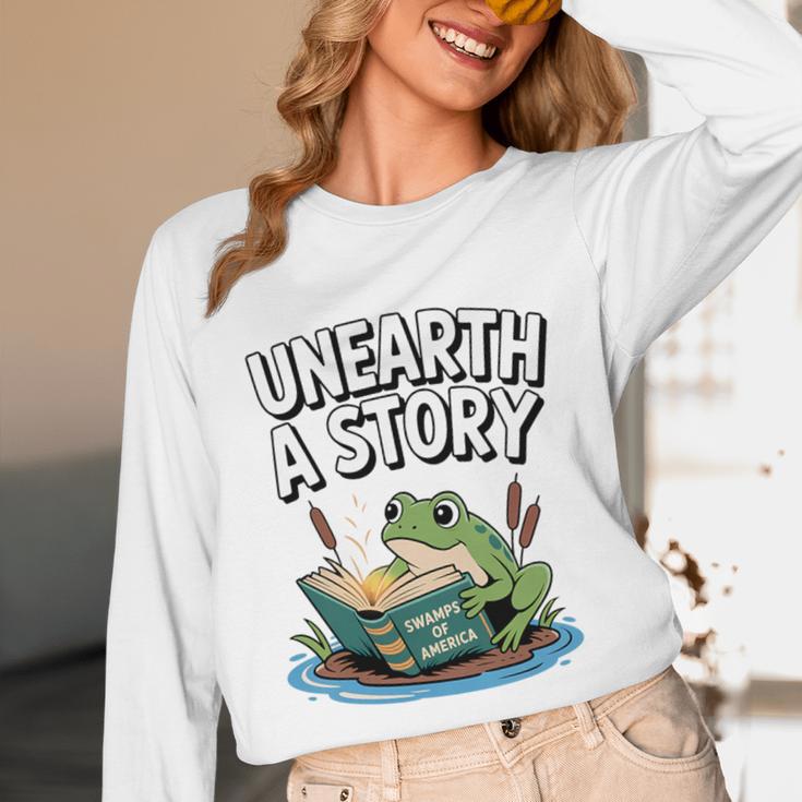 Unearth a Story Frog Reading a Book Summer 2026 Premium Tri-Blend Unisex Long Sleeve T-Shirt Unearth a Story Frog Reading a Book Summer 2026 Premium Tri-Blend Unisex Long Sleeve T-Shirt