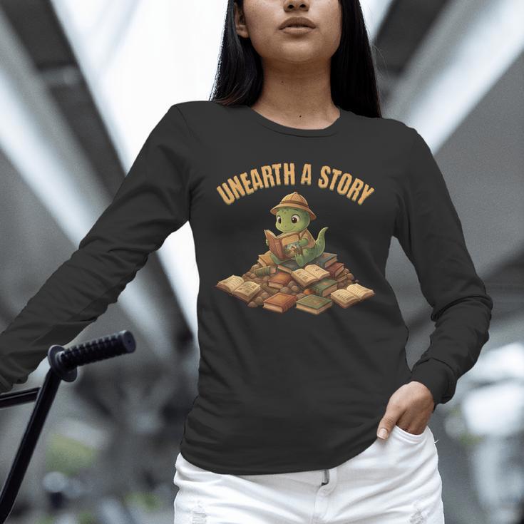 Unearth a Story Dinosaur Reading Books Summer 2026 Unisex Long Sleeve T-Shirt