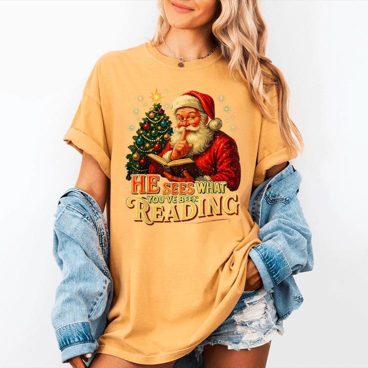 He Sees What You’Ve Been Reading Santa Book Lover Christmas Women's Comfort Colors T-Shirt He Sees What You’Ve Been Reading Santa Book Lover Christmas Women's Comfort Colors T-Shirt