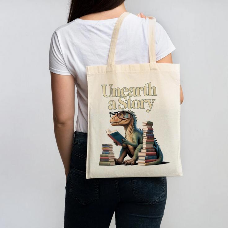 Women's Unearth A Story Dinosaur Reading a Library Book Canvas Tote Bag