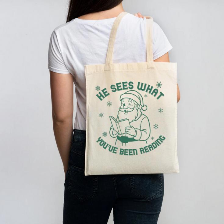 He Sees What You'Ve Been Reading Christmas Bookish Santa Premium Tri-Blend Canvas Tote Bag