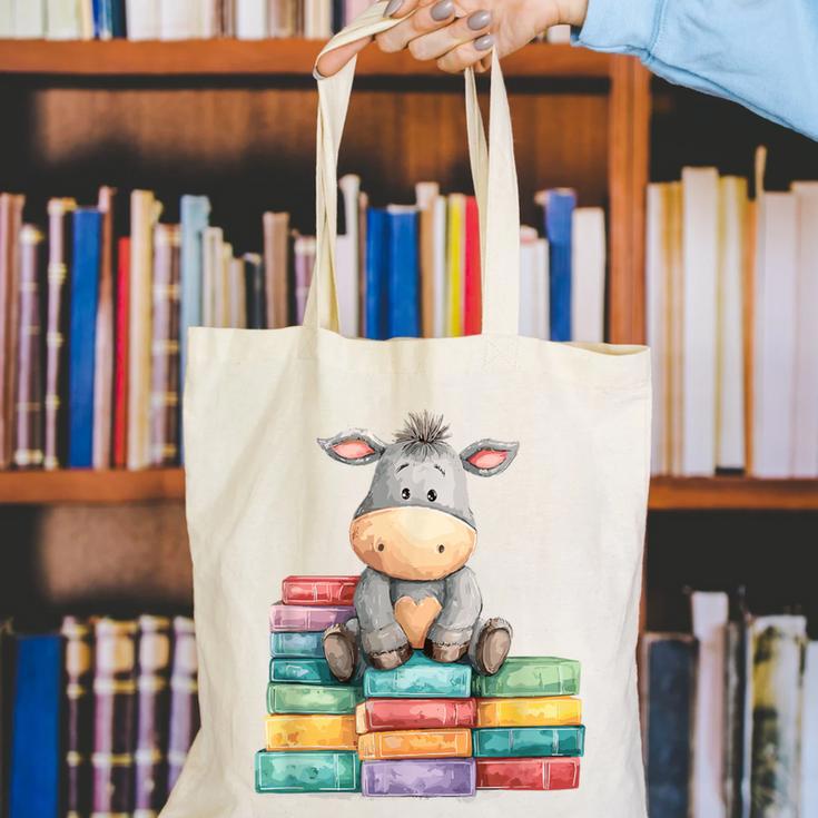 Adorable Donkey With Heart Sitting On Colorful Book Stack Canvas Tote Bag