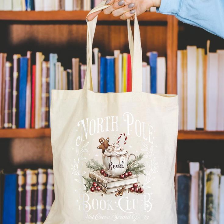 North Pole Book Club Hot Cocoa Served Daily Canvas Tote Bag North Pole Book Club Hot Cocoa Served Daily Canvas Tote Bag