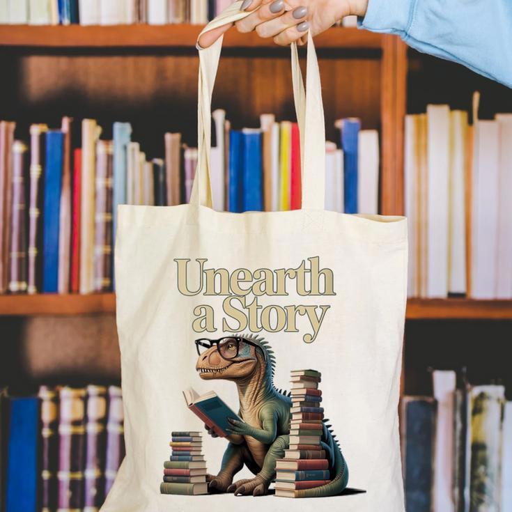 Women's Unearth A Story Dinosaur Reading a Library Book Canvas Tote Bag Women's Unearth A Story Dinosaur Reading a Library Book Canvas Tote Bag