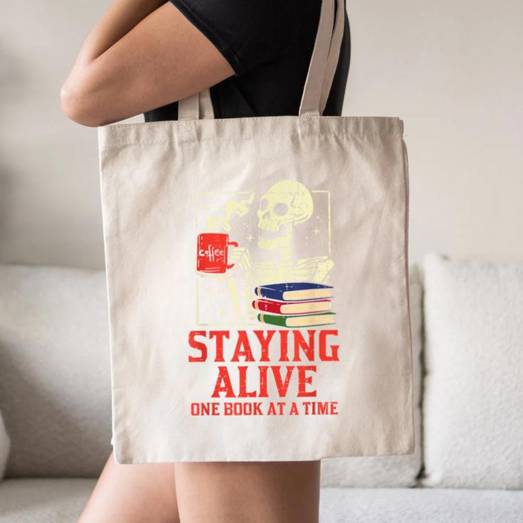 Staying Alive One Book At A Time Skeleton Reading Librarian Canvas Tote Bag Staying Alive One Book At A Time Skeleton Reading Librarian Canvas Tote Bag