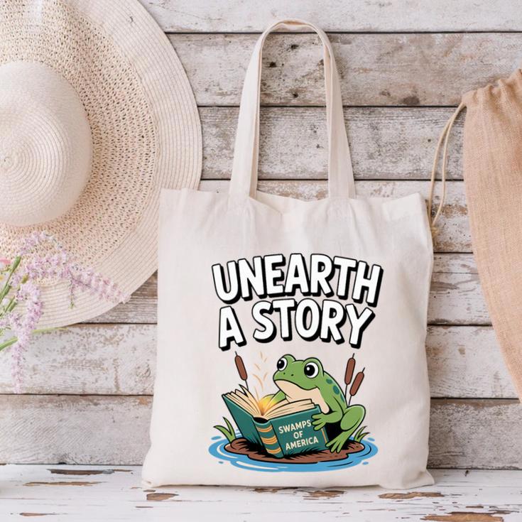 Unearth a Story Frog Reading a Book Summer 2026 Premium Tri-Blend Canvas Tote Bag