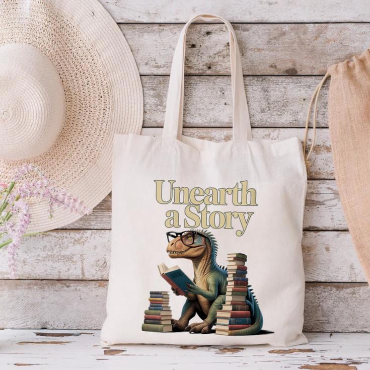 Women's Unearth A Story Dinosaur Reading a Library Book Canvas Tote Bag Women's Unearth A Story Dinosaur Reading a Library Book Canvas Tote Bag