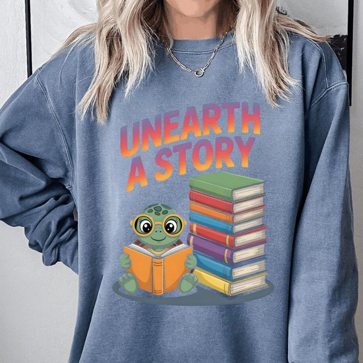 Unearth A Story Cute Turtle Reading Books Librarian Comfort Colors Sweatshirt