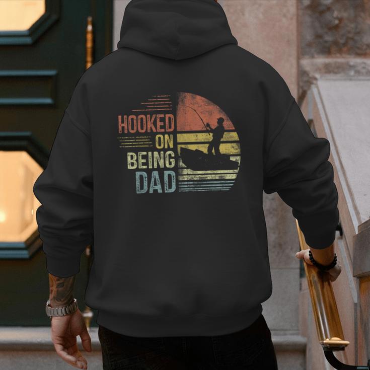 Hooked On Being Dad Fishing Dad Father's Day Men's Hoodie Back Print
