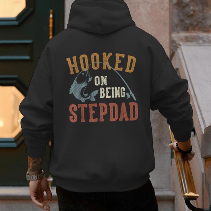 Hooked On Being Stepdad Father's Day Fishing Stepdad Men's Hoodie Back Print
