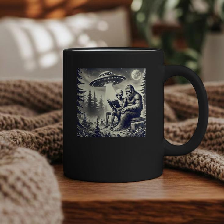 Bigfoot With Alien Reading A Book Bigfoot And UFO Graphic Print Coffee Mug