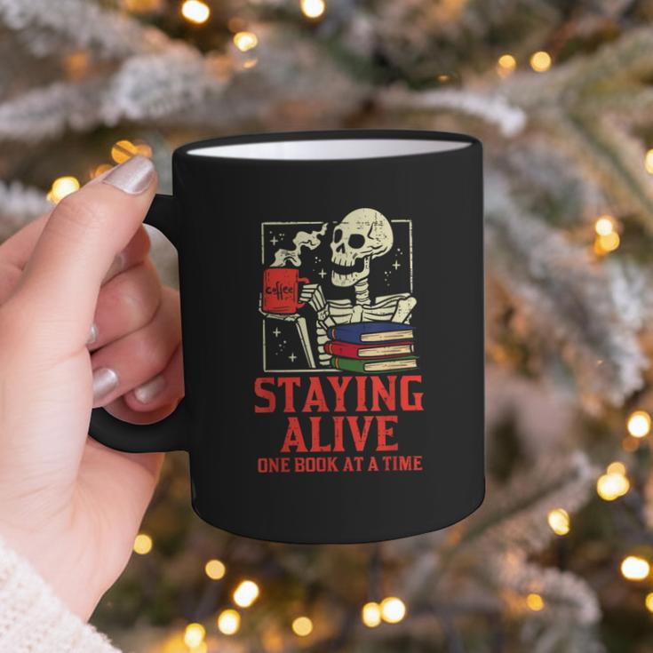Staying Alive One Book At A Time Skeleton Reading Librarian Graphic Print Coffee Mug